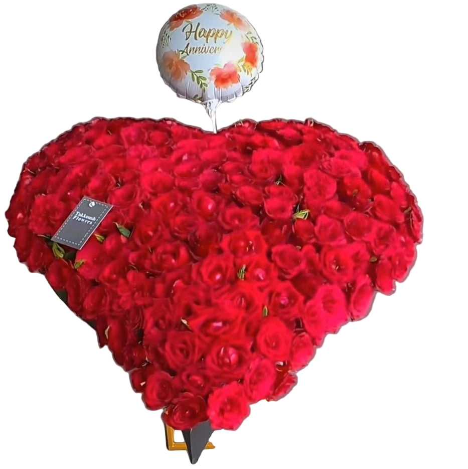 Luxurious heart-shaped red roses arrangement with balloon. Handcrafted by Takkoush Flowers. Same-day delivery in Beirut, Lebanon. Order now.