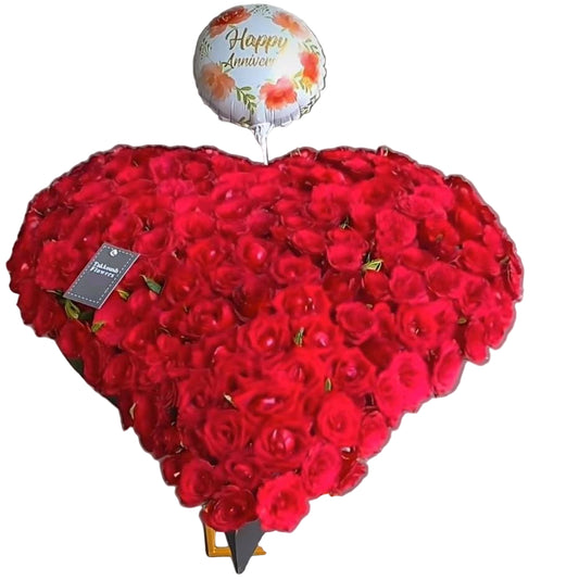 Luxurious heart-shaped red roses arrangement with balloon. Handcrafted by Takkoush Flowers. Same-day delivery in Beirut, Lebanon. Order now.