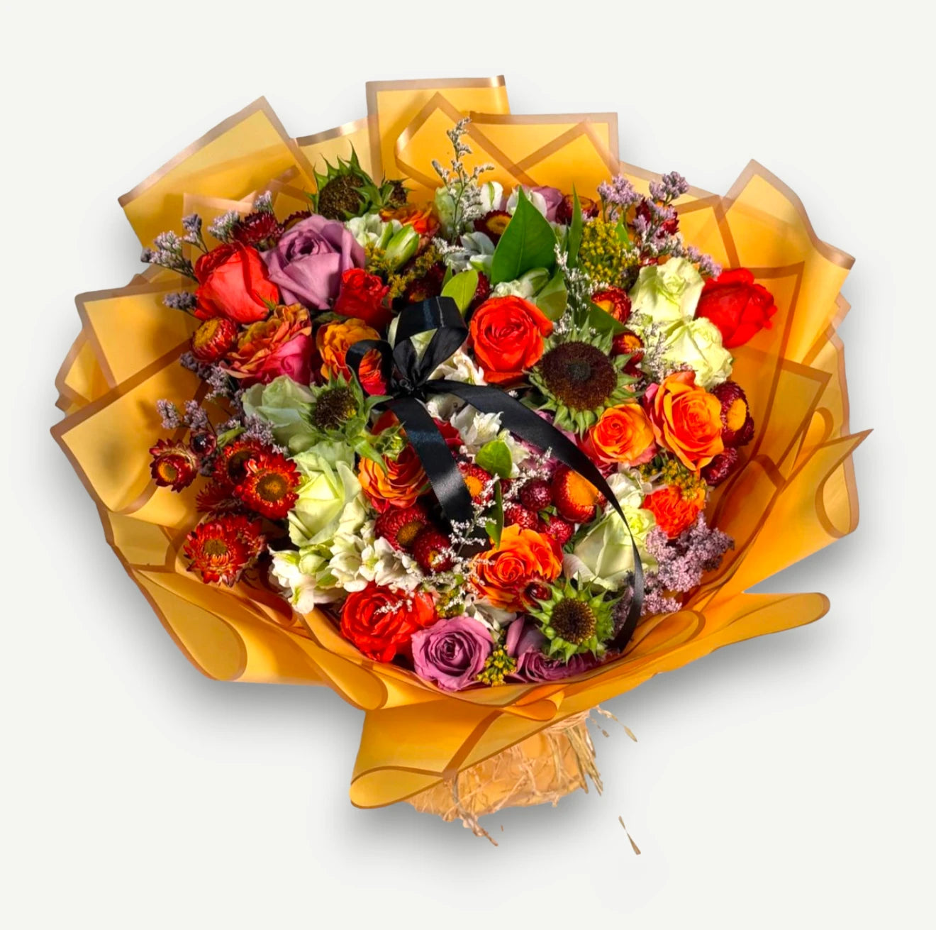 Colorful bouquet of orange, red and mauve roses, sunflowers, white gerberas and red strawflowers, tied with a black ribbon in orange paper