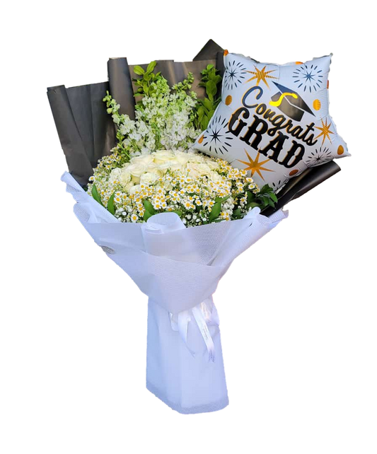 A graduation bouquet featuring white roses and daisies, wrapped in white paper with a 'Congrats Grad!' star-shaped balloon attached.