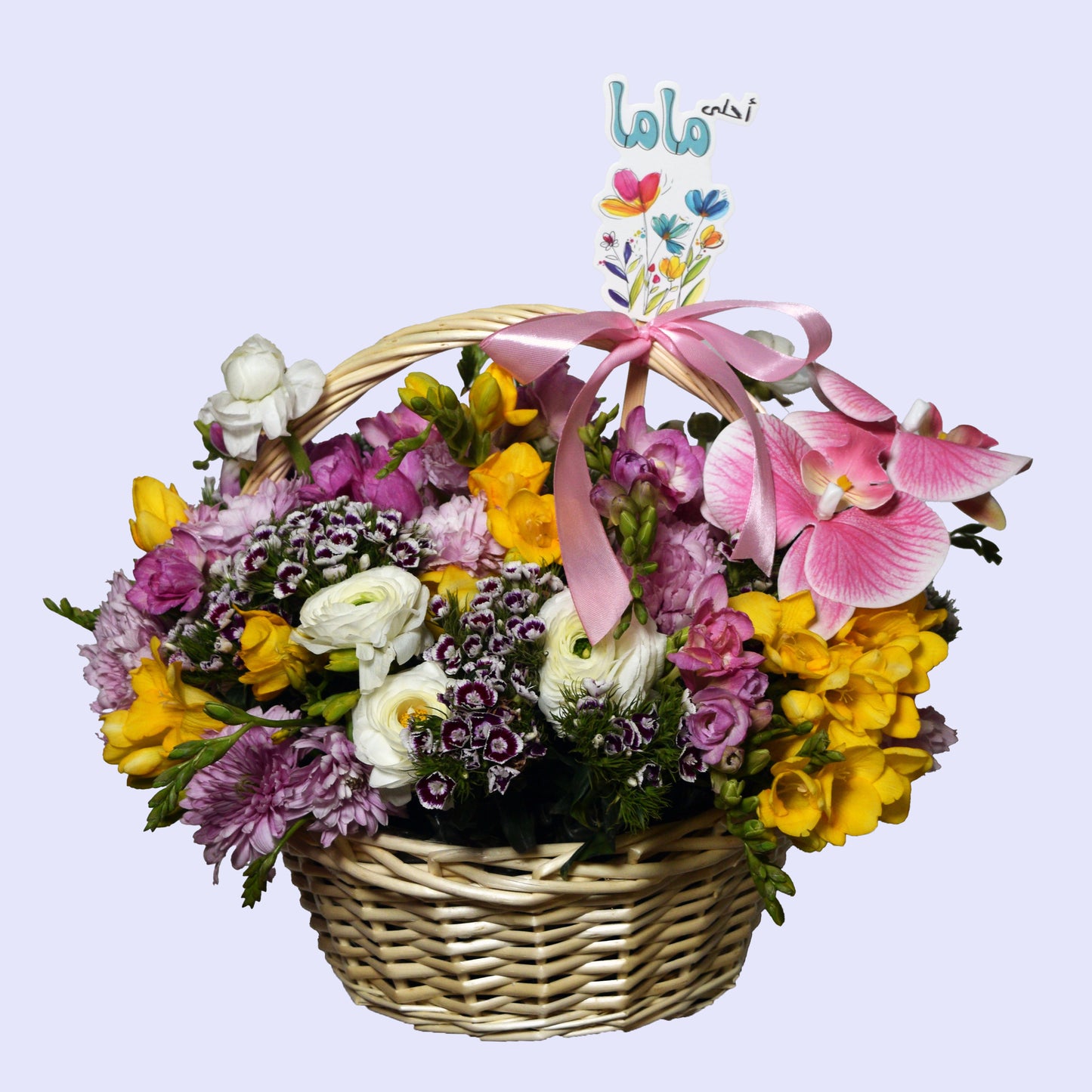 Mixed flower basket with freesias, ranunculus, dianthus, orchids and chrysanthemums with "أحلى ماما" card and satin ribbon — Mother's Day gift with same-day delivery in Beirut Lebanon