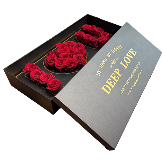 Luxury black and gold rose box with premium red roses arranged inside for Valentine’s Day gift.