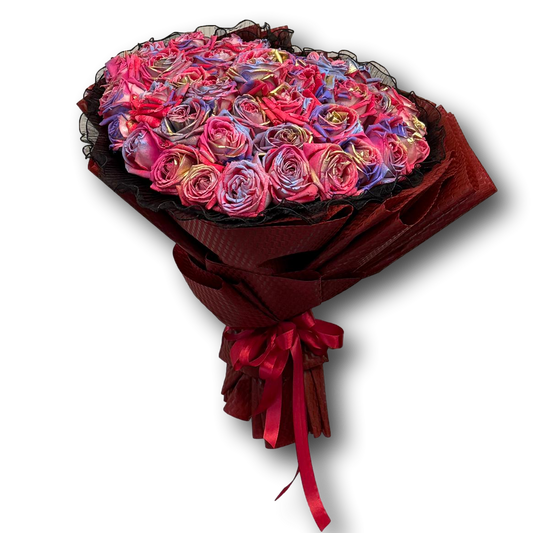Bouquet of colorful roses wrapped in red paper with a red ribbon on a white background