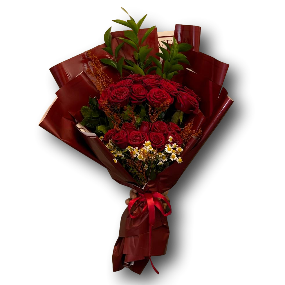 Bouquet of red roses with greenery wrapped in brown paper and a red ribbon on a white background
