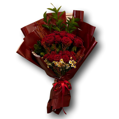 Bouquet of red roses with greenery wrapped in brown paper and a red ribbon on a white background