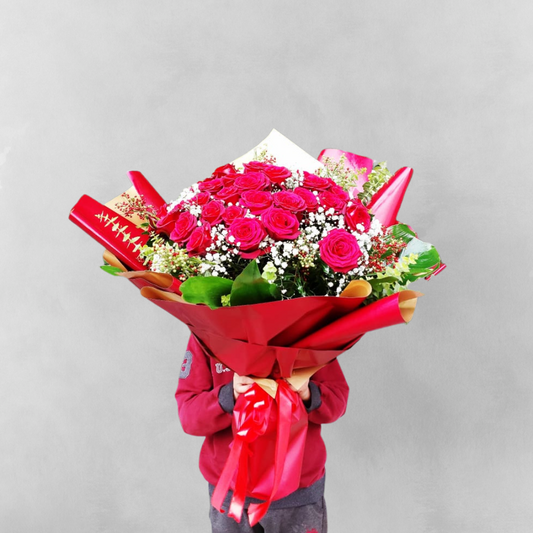 Make a bold statement of love with the Lovers' Bouquet - Two Dozen Red Roses. This breathtaking bouquet features two dozen of the most vibrant red roses, arranged in a way that showcases their beauty and elegance. The rich color of the roses represents love and passion, and the sheer size of the bouquet is sure to impress. Ideal for any romantic occasion, the Lovers' Bouquet is the perfect way to show your affection to someone special.