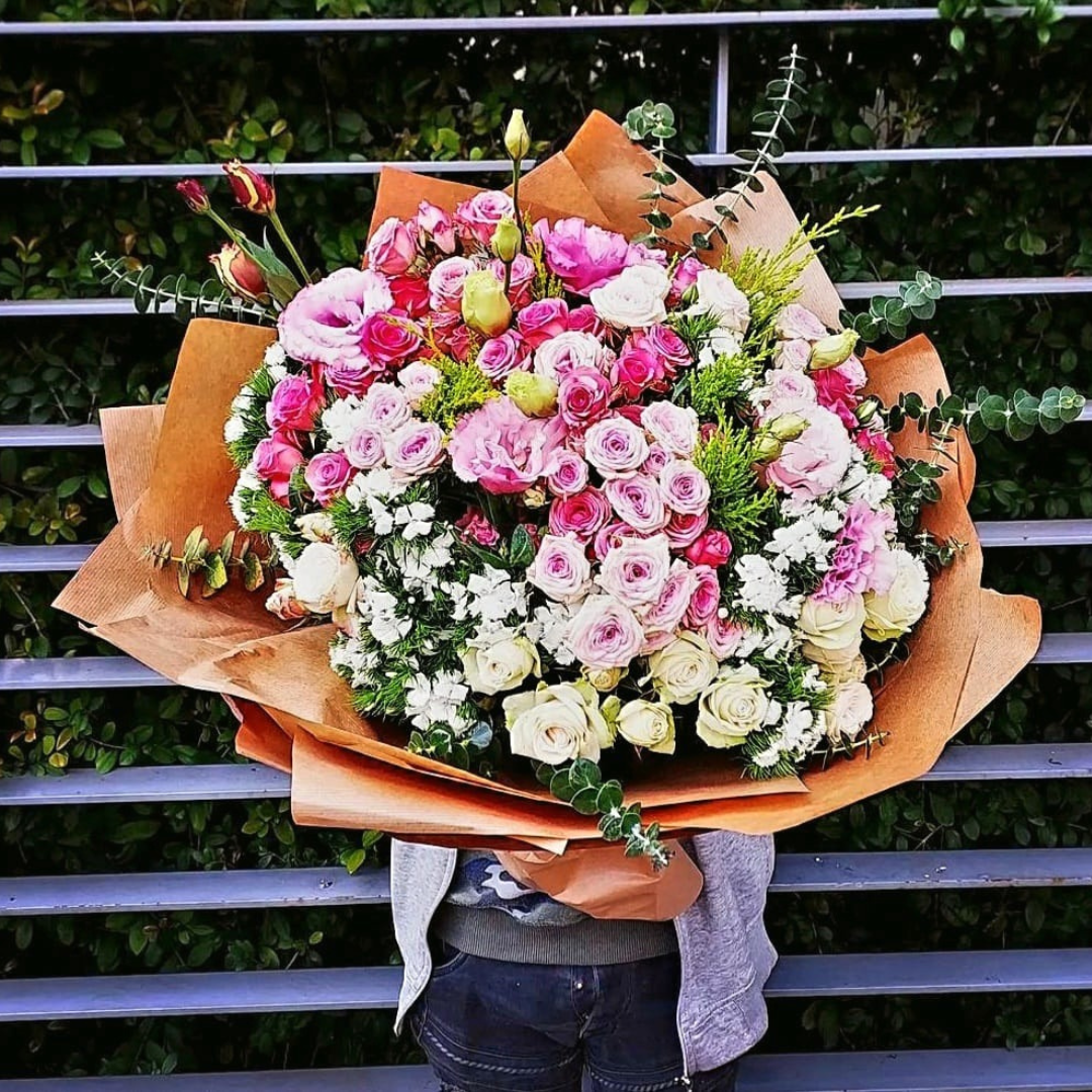 This stunning mix flower bouquet is a perfect combination of pick and white roses, pink estoma flower, and other gorgeous blooms, all expertly arranged with beautiful greenery and elegant accessories. It's an ideal gift for any occasion, from birthdays to anniversaries or simply to brighten someone's day. Order now and let us deliver this breathtaking arrangement straight to your loved one's door.
