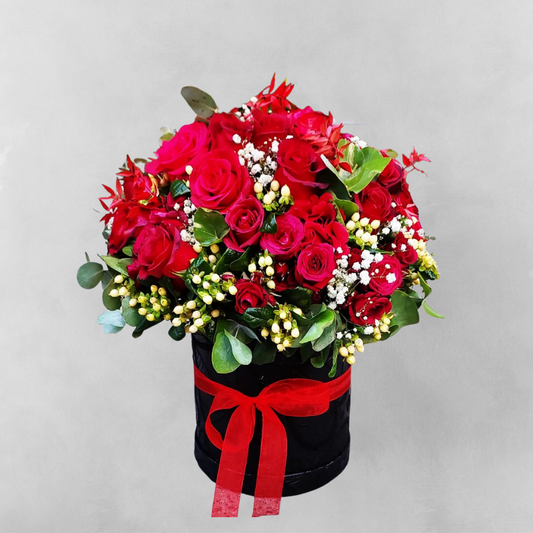 Picture a beautiful box filled with 24 vibrant red roses, the perfect way to express your love and affection. This stunning bouquet of two dozens red roses is arranged in a chic and modern box, making it a unique and unforgettable gift. The lush green foliage and velvety petals are sure to leave a lasting impression on your special someone. Show your love with the Love in a Box, available now at our ecommerce store.